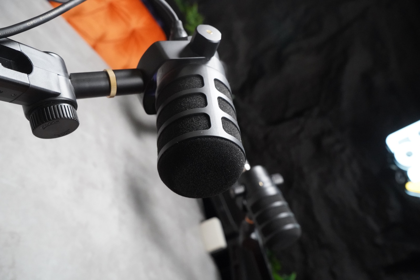 Close detail of a professional microphone inside the PodLot studio